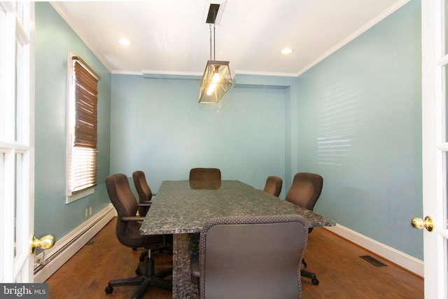 dining area with crown molding, a baseboard heating unit, and wood finished floors