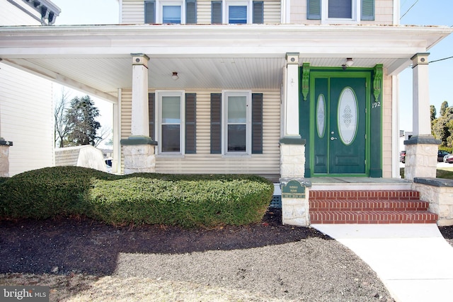 view of exterior entry with covered porch