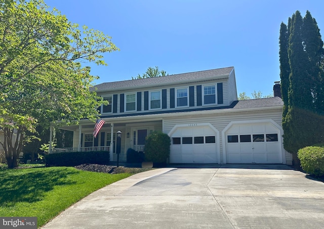 traditional-style home featuring a chimney, concrete driveway, a porch, and a front yard