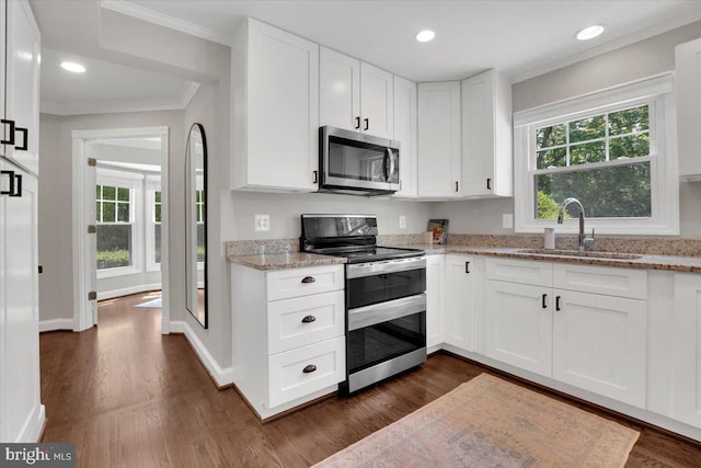 12649 Thunder Chase Dr, Reston, VA 20191 - kitchen featuring stainless steel appliances, a sink, ornamental molding, dark wood-type flooring, and light stone counters