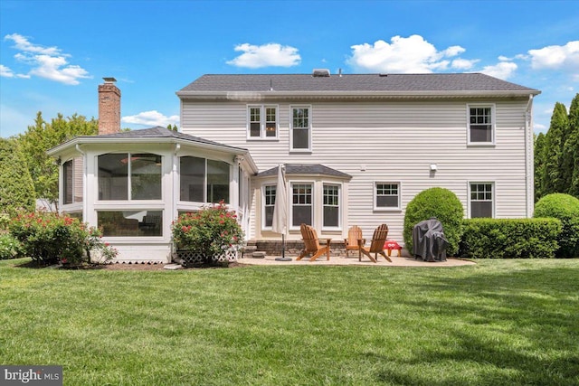 12649 Thunder Chase Dr, Reston, VA 20191 - rear view of house featuring a patio area, a chimney, a yard, and a sunroom