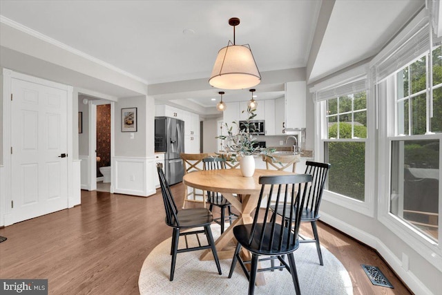 12649 Thunder Chase Dr, Reston, VA 20191 - dining area with wood finished floors, ornamental molding, and a wainscoted wall