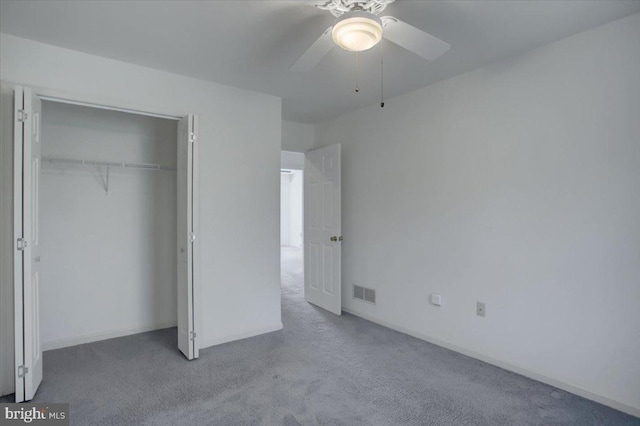 unfurnished bedroom with a ceiling fan, visible vents, carpet, and a closet