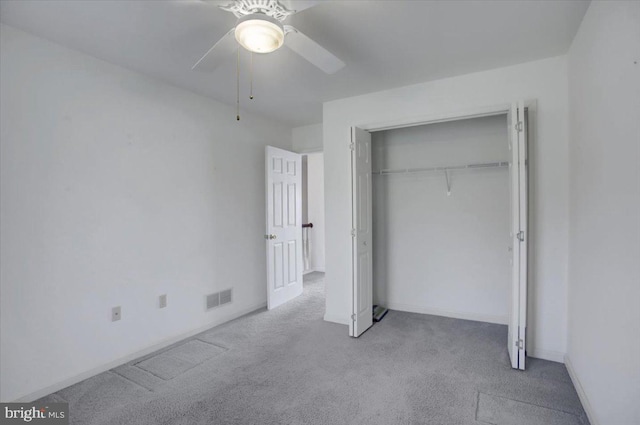 unfurnished bedroom with carpet floors, ceiling fan, a closet, and visible vents