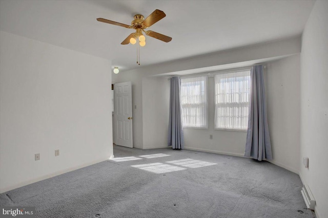 carpeted empty room with a ceiling fan