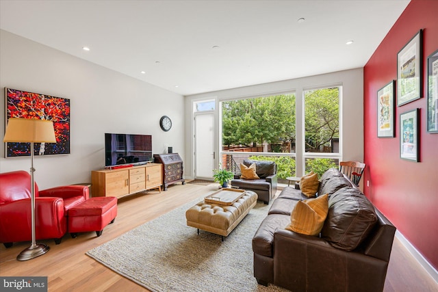 living room with recessed lighting and wood finished floors