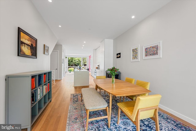 dining area featuring light wood-type flooring, recessed lighting, and baseboards