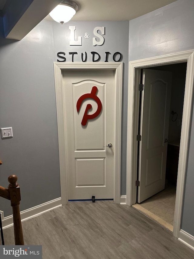 interior space with baseboards and wood finished floors