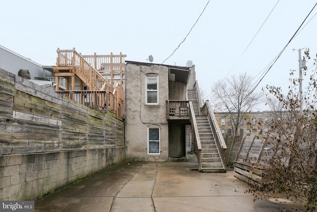 1815 Saint Paul St, Baltimore, MD 21202 - rear view of house with fence, stairs, a patio area, and stucco siding