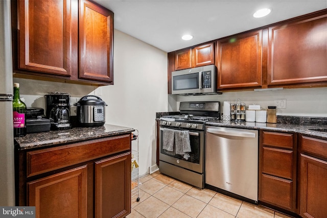1423 Northgate Sq Unit 1423-11C, Reston, VA 20190 - kitchen with stainless steel appliances, light tile patterned floors, recessed lighting, and dark stone countertops