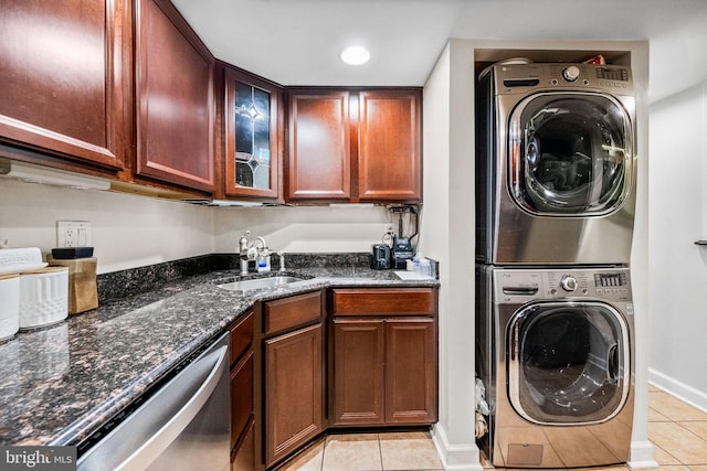 1423 Northgate Sq Unit 1423-11C, Reston, VA 20190 - washroom with stacked washer and clothes dryer, light tile patterned flooring, bar with sink, and baseboards