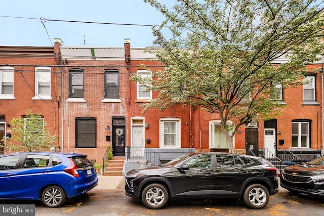 view of property featuring brick siding
