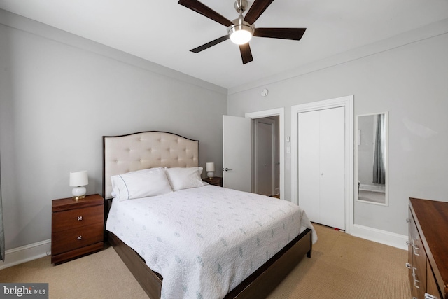 bedroom featuring baseboards, ceiling fan, and light colored carpet