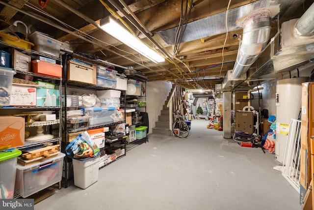 unfinished basement featuring water heater, heating unit, and stairs
