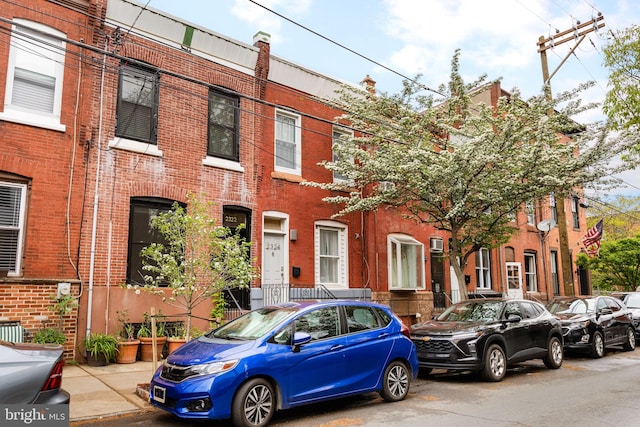 townhome / multi-family property featuring brick siding