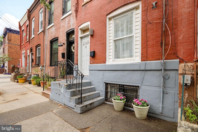 view of exterior entry with brick siding
