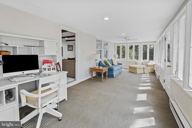 carpeted office space with a ceiling fan, baseboards, recessed lighting, and a baseboard radiator