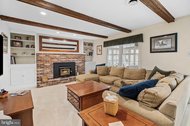 living area featuring carpet flooring, beam ceiling, a fireplace, built in shelves, and recessed lighting