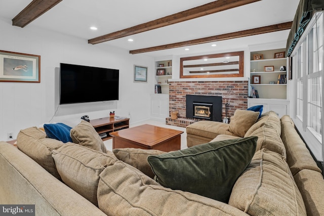 living room featuring a brick fireplace, recessed lighting, built in features, and beam ceiling