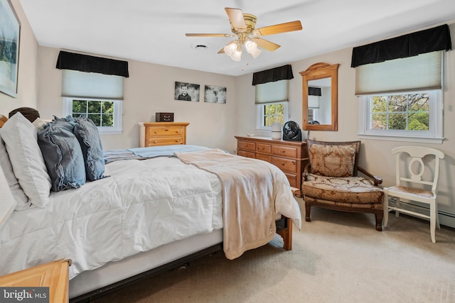 bedroom featuring a ceiling fan, multiple windows, and carpet