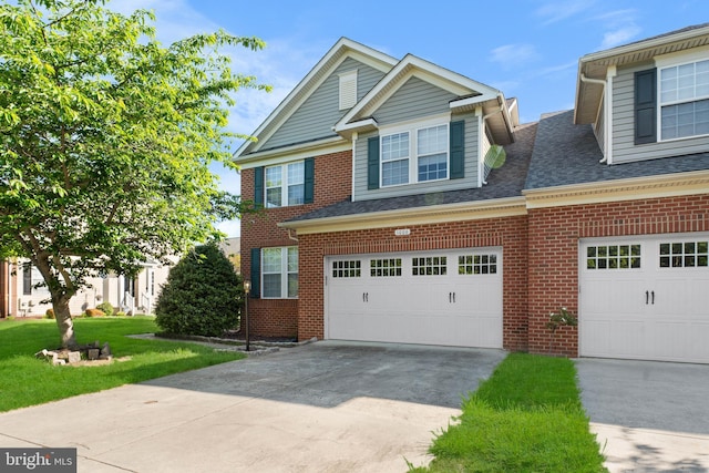 view of front facade featuring brick siding, driveway, roof with shingles, and a front lawn