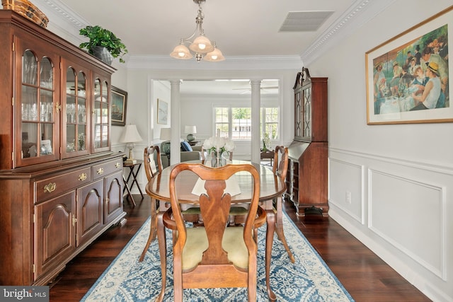 dining area with crown molding, a decorative wall, ornate columns, and visible vents