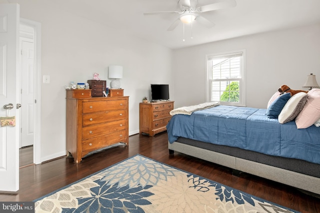 bedroom with baseboards, ceiling fan, and wood finished floors