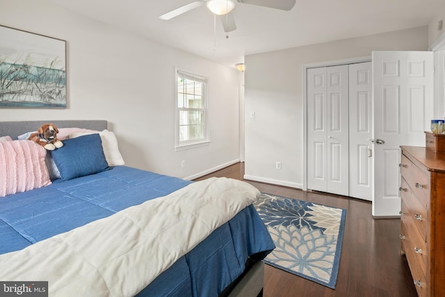 bedroom with baseboards, a ceiling fan, a closet, and dark wood-type flooring