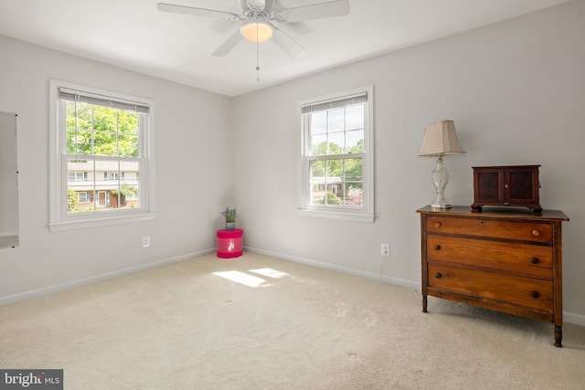 carpeted bedroom featuring baseboards and a ceiling fan