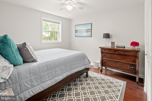 bedroom with baseboards, ceiling fan, and wood finished floors