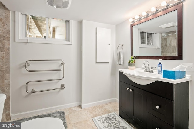 bathroom with visible vents, vanity, toilet, baseboards, and tile patterned floors