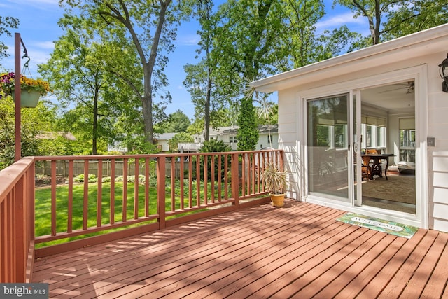 wooden terrace with a lawn