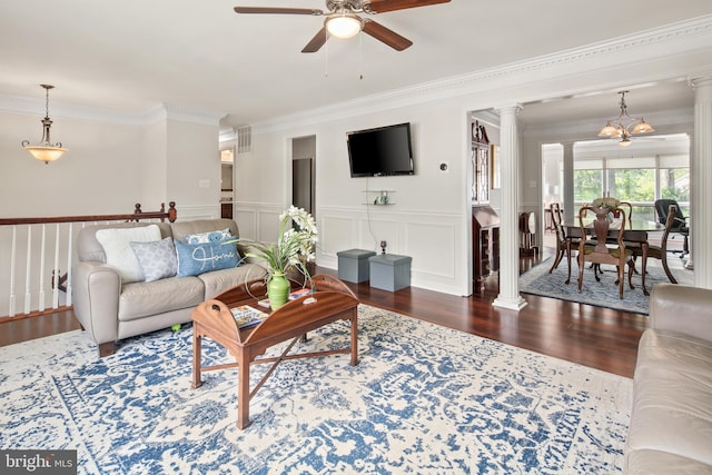 living room featuring a ceiling fan, decorative columns, visible vents, crown molding, and wood finished floors