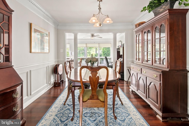dining space featuring crown molding, wainscoting, decorative columns, and dark wood-style floors