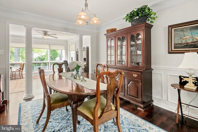 dining area with a decorative wall, ornate columns, wainscoting, and dark wood-type flooring