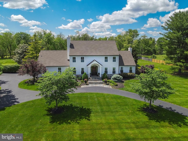 1071 Highland Rd, Newtown, PA 18940 - colonial inspired home featuring a chimney, stucco siding, and driveway