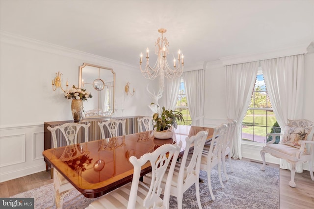 1071 Highland Rd, Newtown, PA 18940 - dining area with a chandelier, healthy amount of natural light, light wood-style flooring, crown molding, and a decorative wall