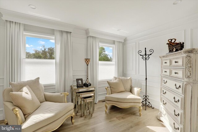 1071 Highland Rd, Newtown, PA 18940 - living area with light wood-type flooring, ornamental molding, and a decorative wall