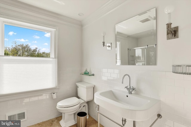 1071 Highland Rd, Newtown, PA 18940 - bathroom with tile walls, toilet, a sink, a shower stall, and wainscoting