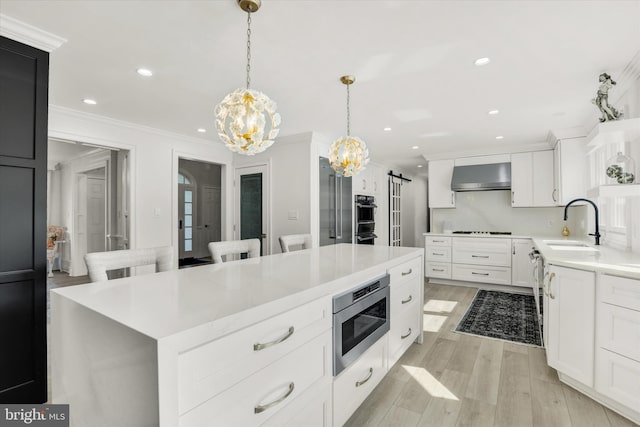 1071 Highland Rd, Newtown, PA 18940 - kitchen with appliances with stainless steel finishes, wall chimney exhaust hood, a chandelier, ornamental molding, and light countertops
