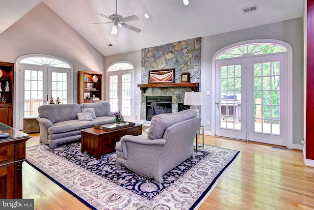 living area featuring french doors, wood finished floors, and visible vents