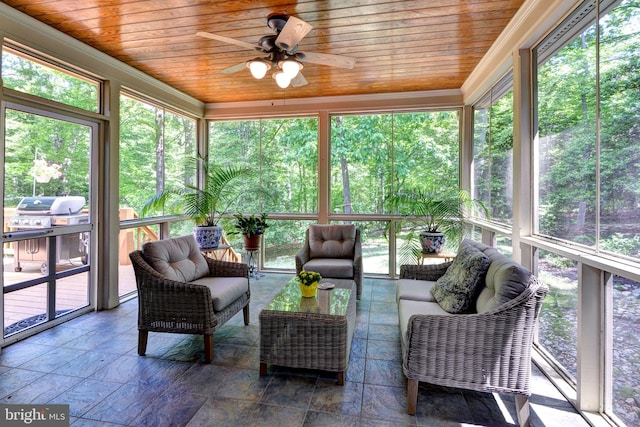 sunroom with ceiling fan and an outdoor hangout area