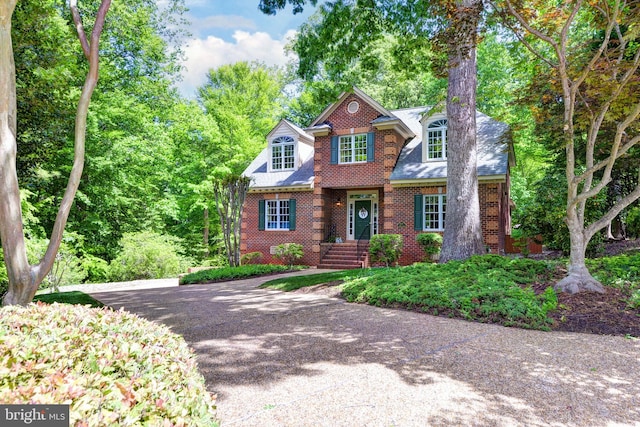 traditional home featuring brick siding