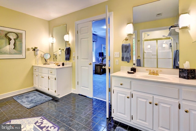full bathroom with a sink, tile patterned flooring, a shower stall, and two vanities