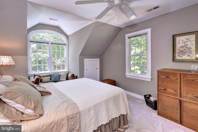 bedroom with visible vents, carpet, lofted ceiling, and multiple windows