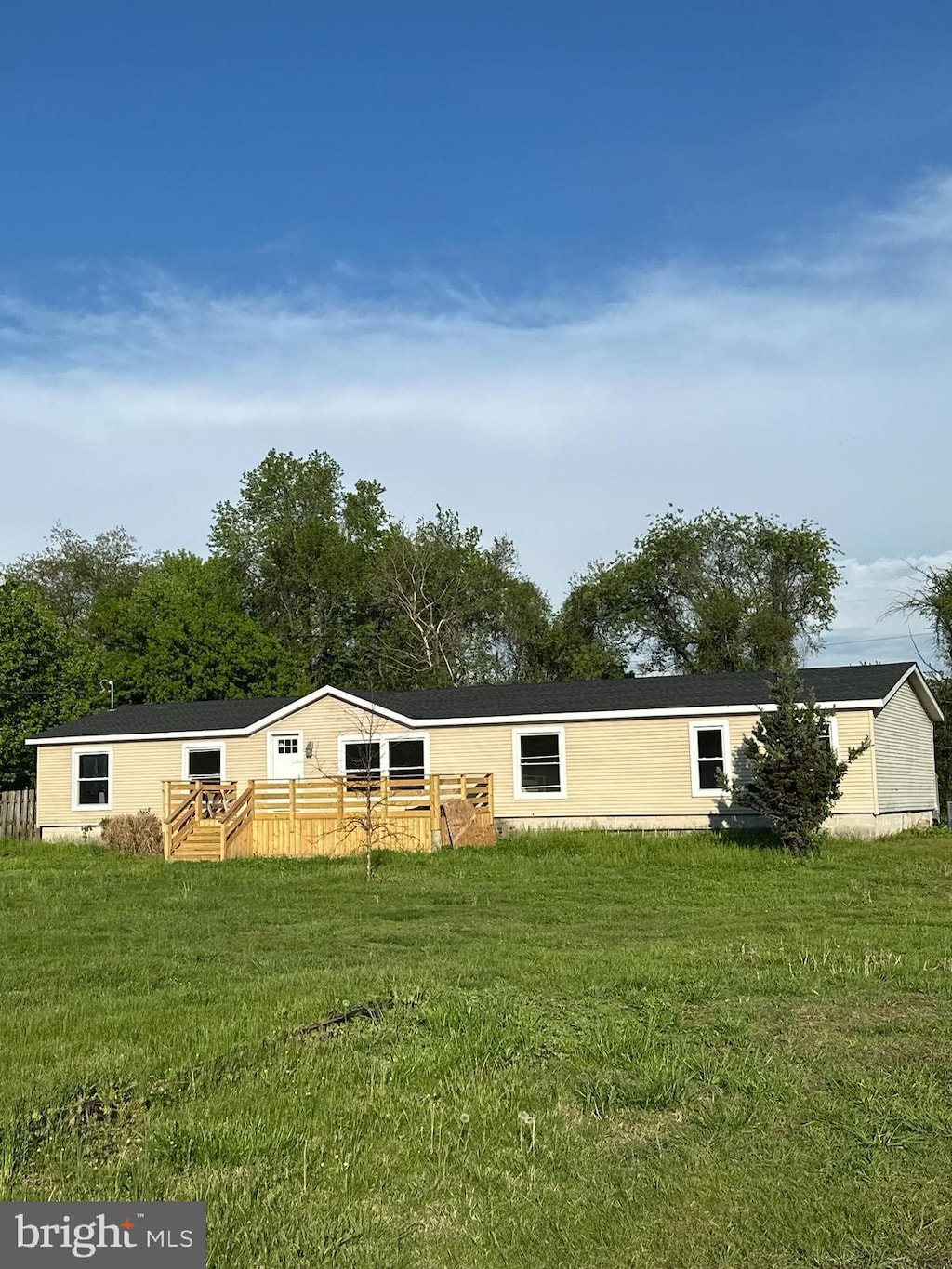 rear view of property with a lawn and a deck
