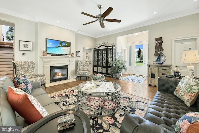 41 Kenmare Way, Rehoboth Beach, DE 19971 - living room with a ceiling fan, a glass covered fireplace, wood finished floors, and a wealth of natural light