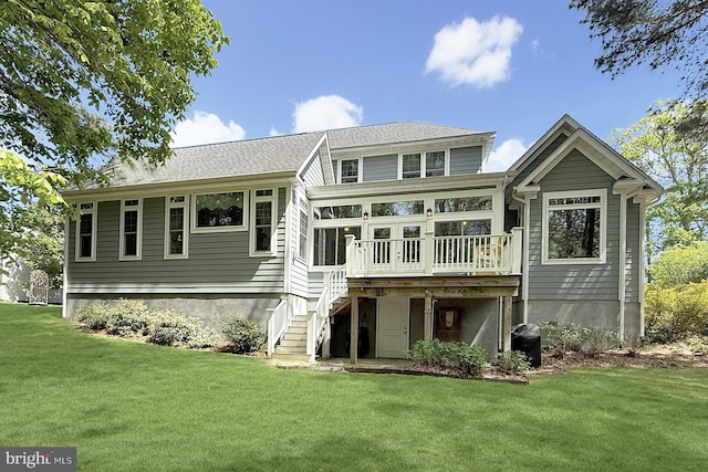 41 Kenmare Way, Rehoboth Beach, DE 19971 - back of house featuring stairway, a deck, a sunroom, and a lawn