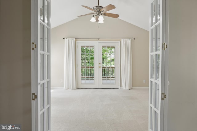 carpeted spare room featuring baseboards, a ceiling fan, french doors, and lofted ceiling