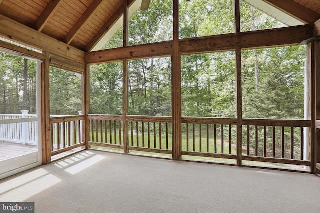 unfurnished sunroom featuring beamed ceiling